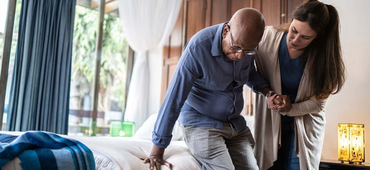 Homecare-professional-helping-senior-Black-man-to-stand_iStock-1313001500_2022-01_hero-1336x614-1